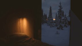 Cozy Nordic cabin interior in Sjusjøen, Norway, warm light glowing beside a window overlooking a snow covered winter landscape and frosted pine trees at sunset. - Powered by Shutterstock - Get 15% off with code: PIKWIZARD15