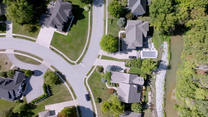 Neighborhood homes in Carmel, Indiana with drone video moving overhead.