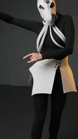 Two contemporary dancers in unicorn masks perform expressive choreography in a studio with dramatic lighting, captured in motion as an avant-garde surreal dance video scene

