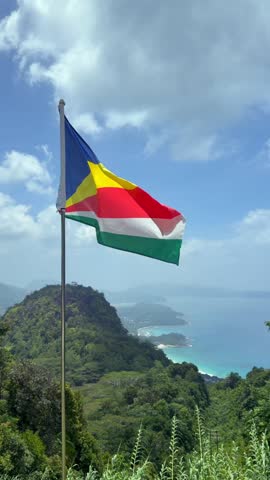 Slow motion of Seychelles flag over the breath taking view from the tea factory, Mahe, Seychelles 25fps