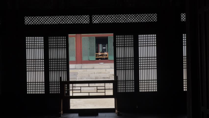 Slow motion landscape view through traditional Korean temple doorway with stairs at Changdeokgung Palace historic shrine landmark in Seoul city South Korea Asia royal heritage architecture and tourism