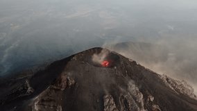 Aerial view of Fuego Volcano crater with glowing lava and steam rising over the surrounding Guatemalan landscape. - Powered by Shutterstock - Get 15% off with code: PIKWIZARD15