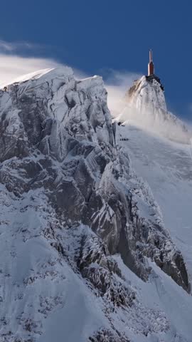 Blowing snow over Aiguille du Midi summit Chamonix France