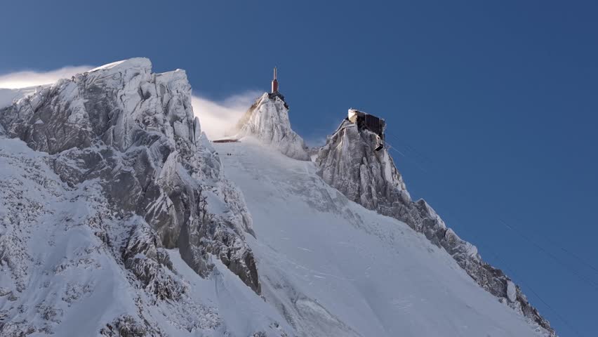 Snowy Aiguille du Midi peaks wind swept in Chamonix France
