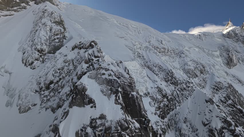 Aiguille du Midi and snowy mountains above Chamonix France