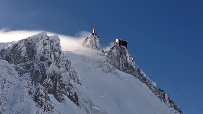 Aiguille du Midi snow capped peak Chamonix France blue sky
