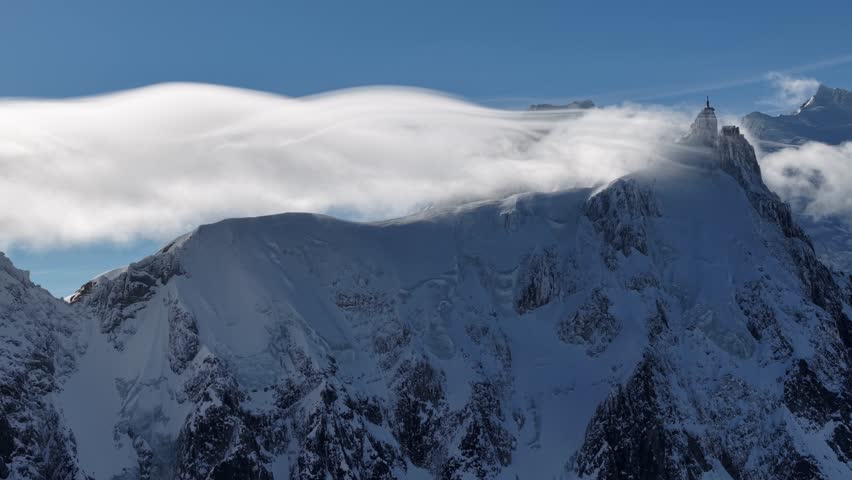 Dynamic clouds over Aiguille du Midi summit Chamonix France