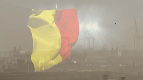 Yellow-red flag fluttering in gusts bulging folding snapping right settling upright hazy skyline. Banner, duotone, textile, outdoor, harbor, cranes, backlit - Powered by Shutterstock - Get 15% off with code: PIKWIZARD15