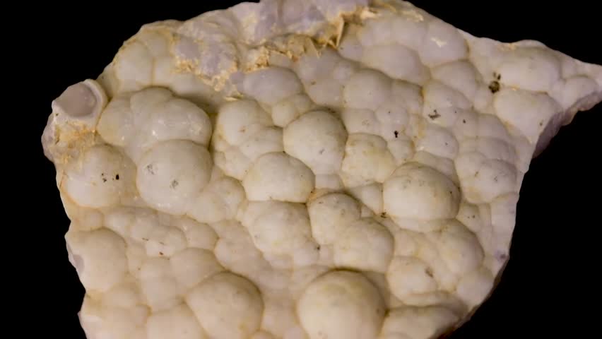Botryoidal Geode, a mineral, grape-like, bubbly surface  black background.