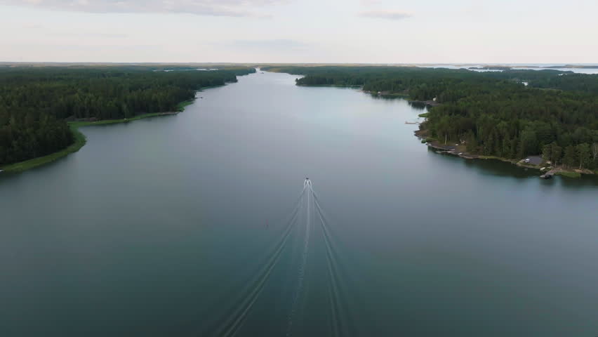 Aerial view following a boat in the finnish archipelago, summer eve in Finland