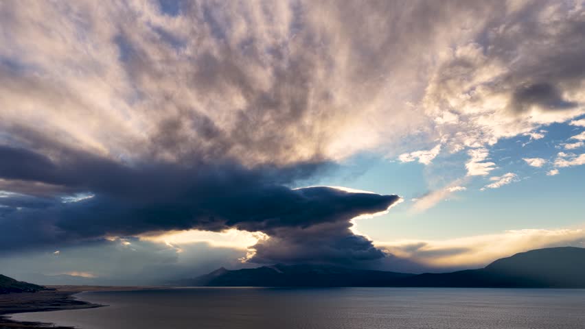 Dramatic cloud formations over Lake Burdur at sunset and golden rays of light in the sky.