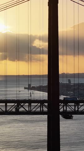 Sunset Sky Over 25 Of April Bridge At Lisbon In Lisbon District Portugal. Sunset Downtown. Freeway Road Landscape. 25 Of April Bridge At Lisbon In Portugal. Cable Stayed Bridge Scenery.