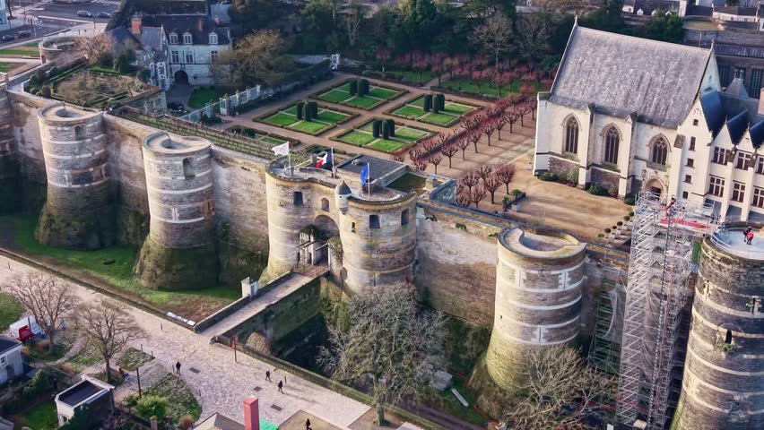 Drone panning over Château d’Angers showing entrance and gardens, France.
