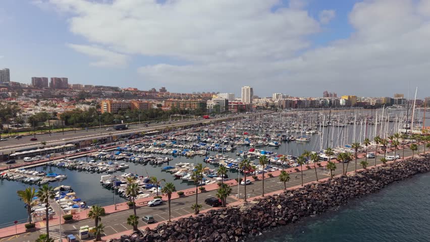 Aerial perspective over the bustling marina port in Las Palmas de Gran Canaria. Numerous yachts and boats are docked in the marina