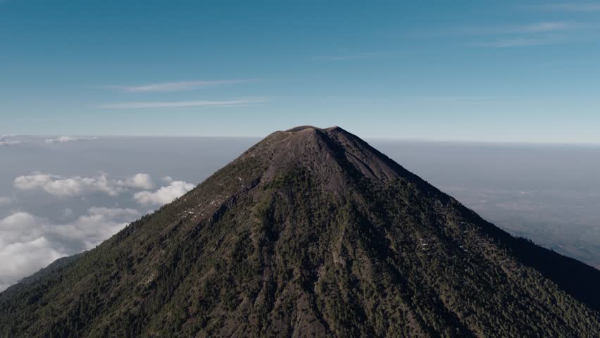 Aerial view of Acatenango Volcano summit rising above clouds in Guatemala.