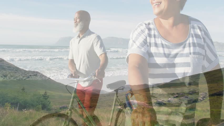 Mature man holding bike woman walking dune dissolving overlay closeup taking ocean view for travel. Coast, shoreline, beach, cycling, couple, senior, seascape