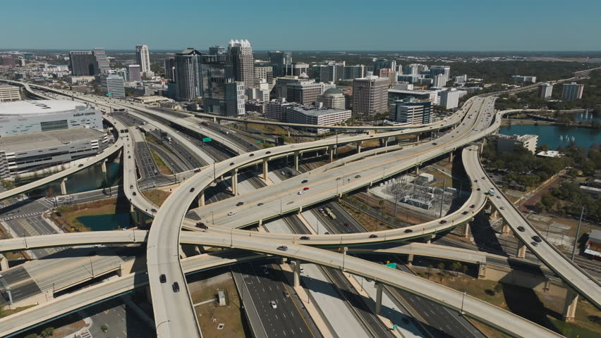 Push-in revealing drone shot over the interchange connector in downtown Orlando.