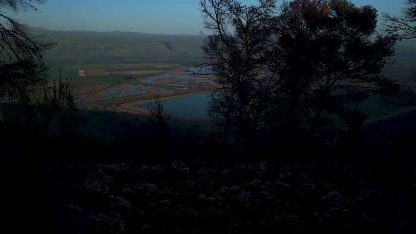 Hula Valley and Golan Heights panorama seen through the natural greenery of Keren Naftali during an aerial flight in Israel.