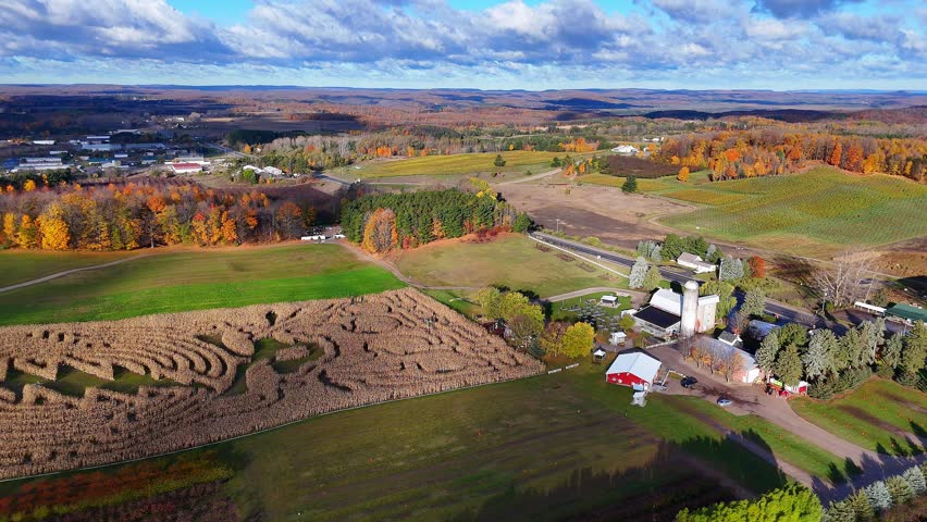 Traverse City Michigan farm buildings with a corn maze showing autumn colours, aerial view