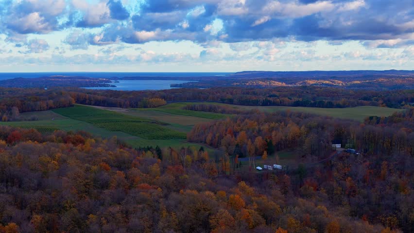 Leelanau County autumn forest with Lake Michigan on the horizon in aerial view