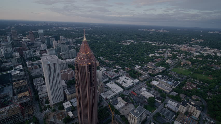 Aerial view of Atlanta, Georgia, at twilight. Features the skyline, Bank of America Plaza, and highways.