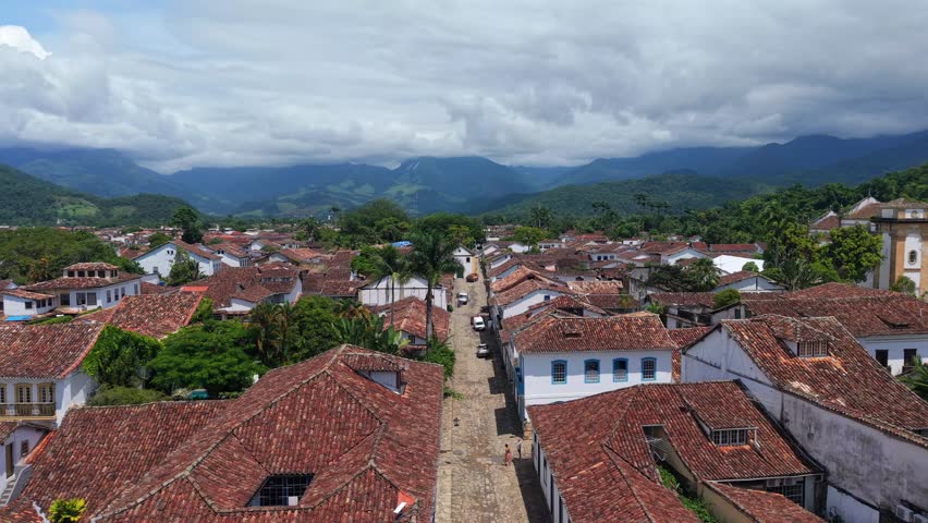 Historic town center with red tile roofs and colonial buildings in Paraty, aerial dolly abstract local neighborhood backdrop