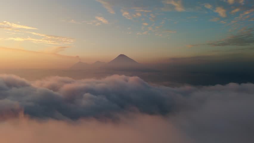 Volcanoes Agua, Acatenango and Fuego in Guatemala. Aerial view above clouds