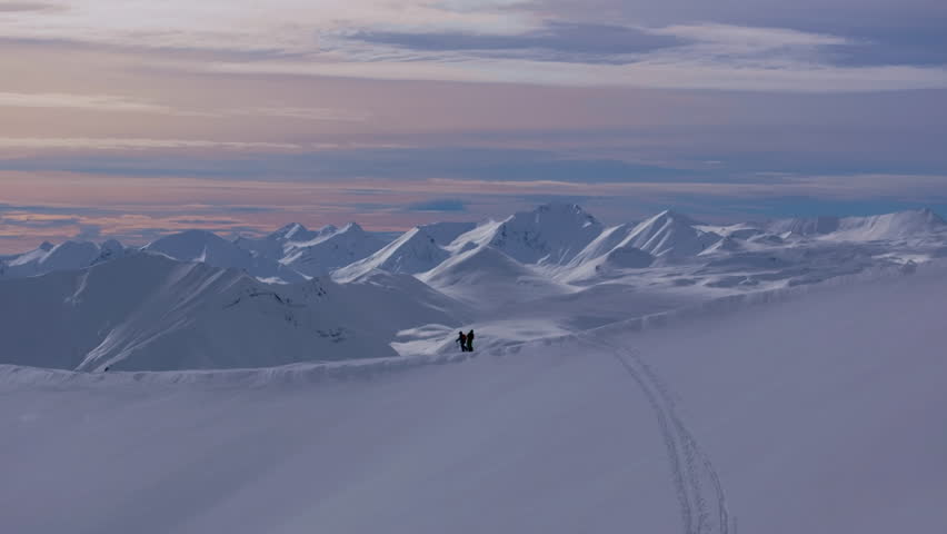 4K aerial drone footage capturing Gudauri Ski Resort in the Caucasus Mountains, featuring two skiers at the top of the mountain. Georgia_034