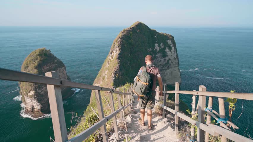 Travel people enjoy amazing view famous landmark and popular travel destination Kelingking beach Nusa Penida, Bali, Indonesia 4K