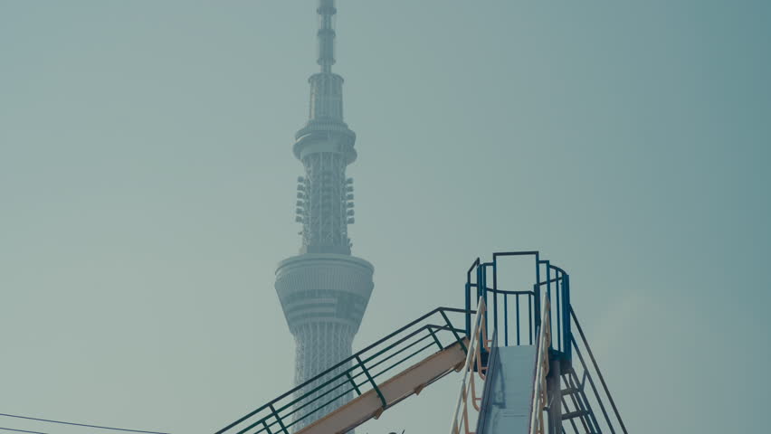 Residential playground in Taito ward with Tokyo Skytree landmark in background.