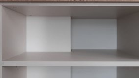 Close up of hands placing spirit level on cabinet shelf inside kitchen cabinet. Using bubble level to verify level during furniture assembly - Powered by Shutterstock - Get 15% off with code: PIKWIZARD15