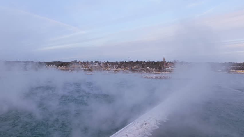 Aerial view through sea smoke, toward Port Washington marina, sunrise in Wisconsin