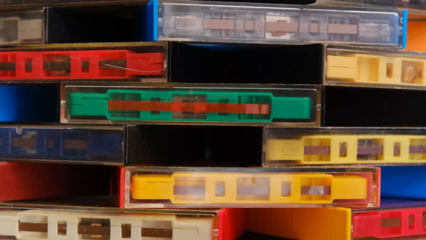 vintage retro audio tape cassettes on a rotating table with a dark background