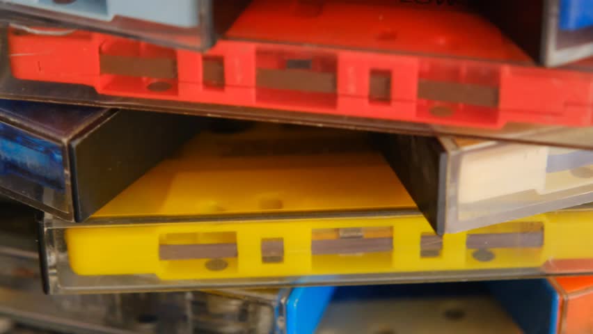 vintage retro audio tape cassettes on a rotating table with a dark background