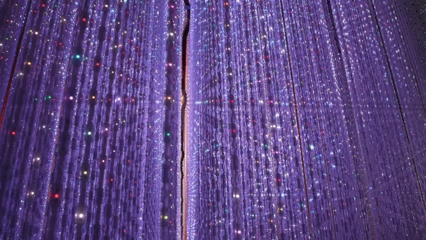 Beautiful lighting artwork with lighting Hundreds of strings of LED lights are hung from the ceiling of mirrored infinity room