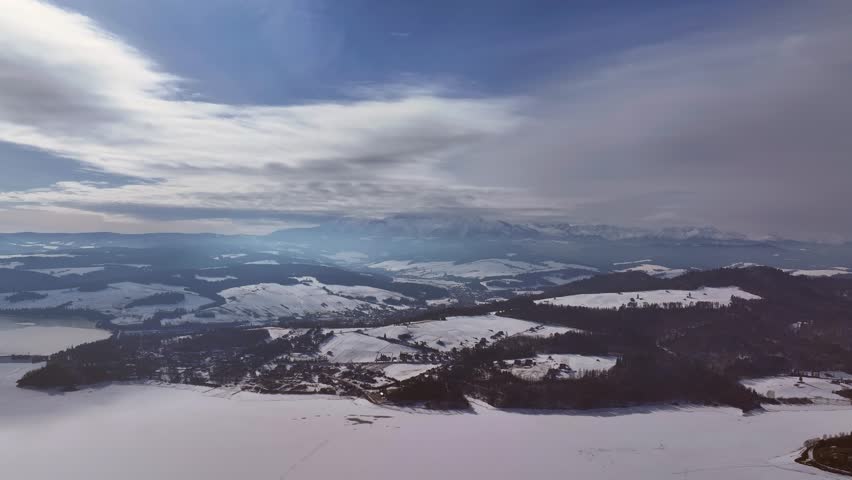 Aerial view of winter landscapes with snow-covered mountains and lakes