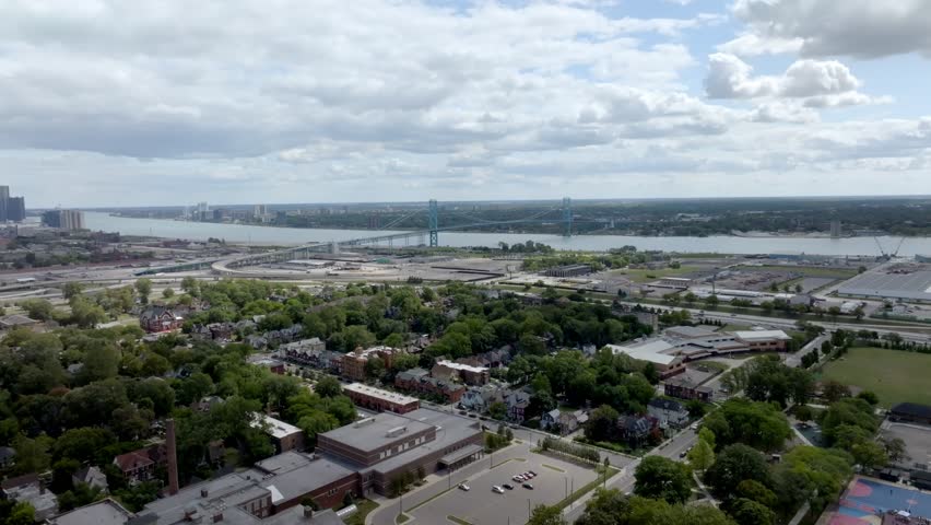 Ambassador Bridge in Detroit, Michigan in the distance with drone video moving in.