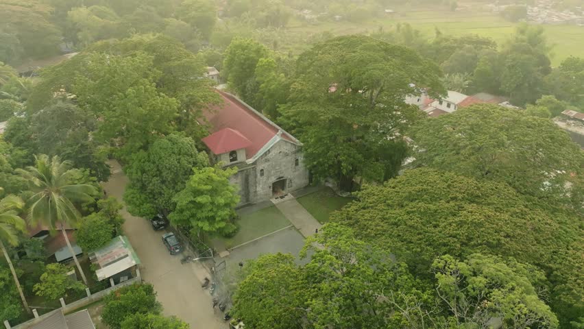 Aerial View of Historical Old Bosoboso Church in Antipolo, Philippines
he historic Old Bosoboso Church (Parish of the Annunciation of the Lord) in Antipolo, Rizal, Philippines. This Spanish-era stone church is nestled within lush tropical greenery. The video captures the rustic stone facade, red roof, and the peaceful morning atmosphere of this heritage site.