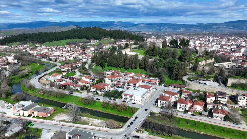 Aerial drone cinematic rotational video of iconic Byzantine castle of Trikala ancient citadel built northeastern side of the city in a small hill featuring clock tower with great views in old city of Trikala, Thessaly, Greece