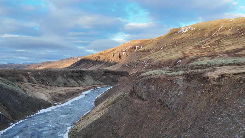 Drone flight around the Porufoss waterfall in Iceland, which is currently beautifully iced over.