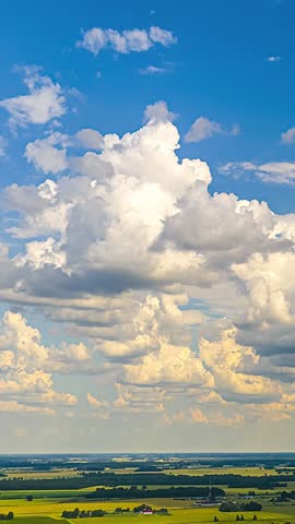 Sunlit clouds over rural landscape, ascend and pull forward, vertical farm timelapse