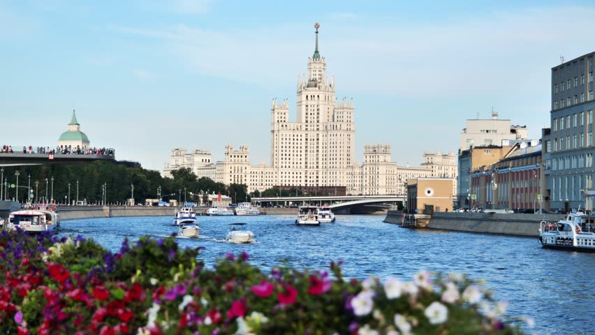 Kotelnicheskaya Embankment Building overlooking Moskva River with boats navigating