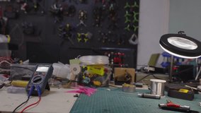 Electronics workbench containing various tools, multimeter, magnifying lamp, soldering supplies, and components, representing assembly, repair, and engineering concepts - Powered by Shutterstock - Get 15% off with code: PIKWIZARD15