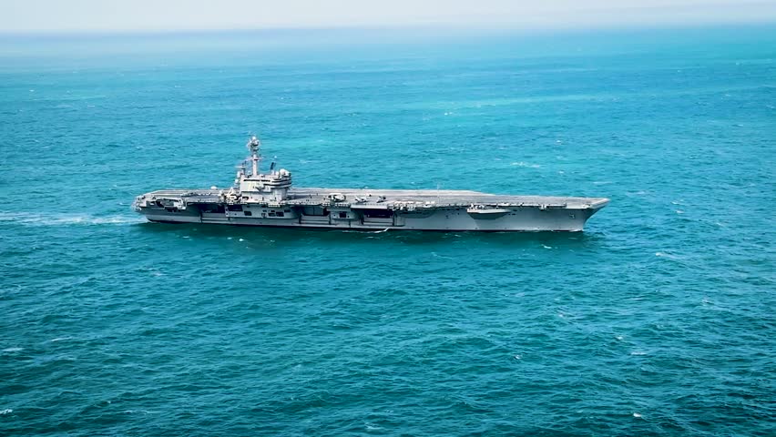 U.S. Navy Aircraft Carrier Transits Vast Blue Waters During Routine Maritime Patrol Operations.