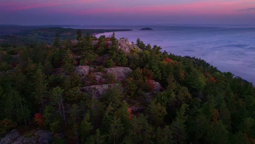 Drone shot of Sugarloaf Mountain viewing location on Lake Superior at sunrise.