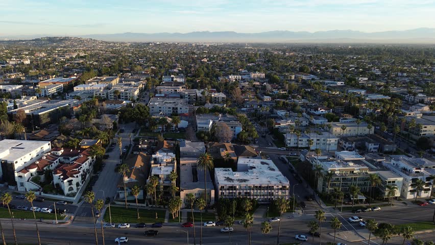 Inland neighborhood density by Belmont Shore streets extends toward Redondo Ave with tightly packed residential blocks and visible commercial edges. Varied rooflines, palm rows, Long Beach, CA. USA