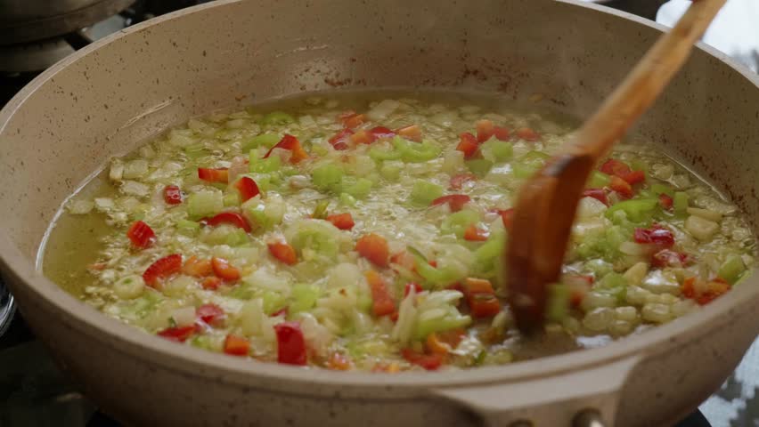 Sauteing Green Peppers Red Peppers and Onions in a Pan
