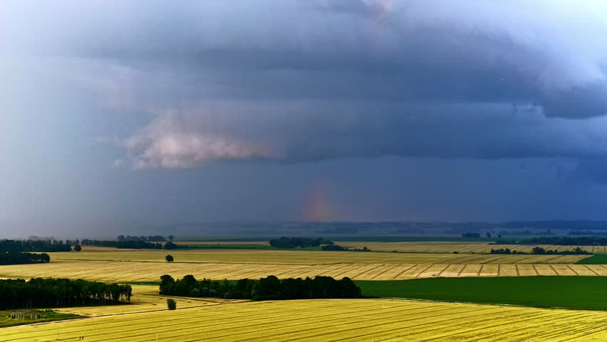Aerial view of agricultural landscape under approaching storm clouds