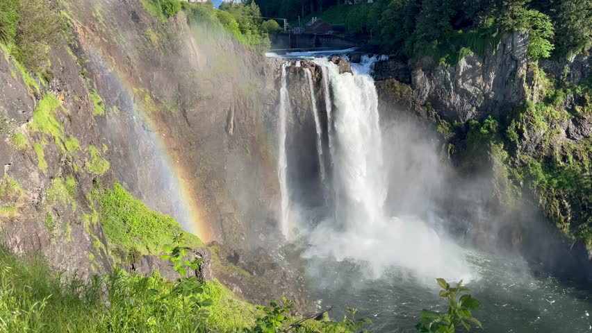 Beautiful Scenic rainbow at Snoqualmie falls waterfall on a sunny day in Washington