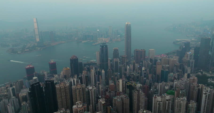 Hong Kong Skyline At Foggy Sunset Seen From Victoria Peak. Aerial Shot